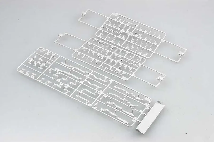Three grey plastic model kit sprues containing various small parts for a 1/700 scale ship model, laid out on a plain light grey background.