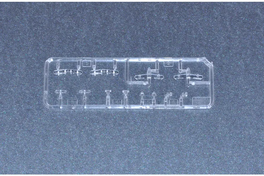 A clear plastic sprue containing small model aircraft parts for a 1/700 scale ship kit.
