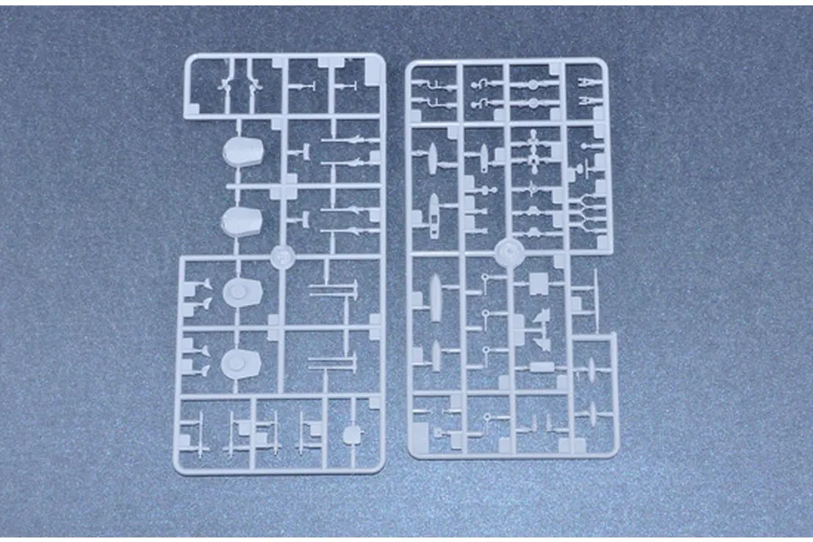 Two grey plastic model kit sprues containing various small parts for a 1/700 scale battleship model.