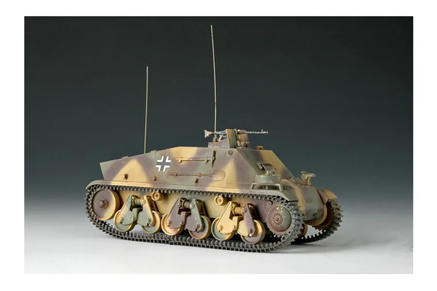 A 1/35 scale model of a German Artillery Observation 38h vehicle, painted in a camouflage pattern with two tall radio antennas.