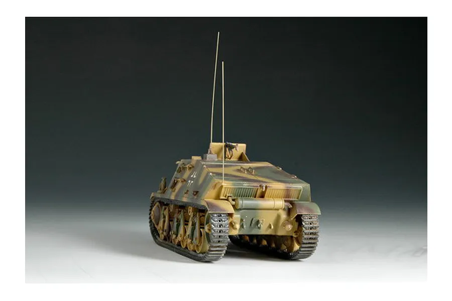 A 1/35 scale model of a German Artillery Observation 38h vehicle, painted in a camouflage pattern with two tall radio antennas.