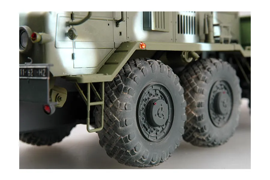 Close-up side view of a 1/35 scale KZKT-537L military truck model showing the front wheels, fender, and chassis details.