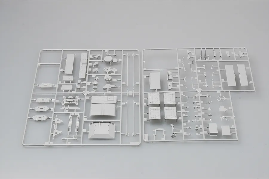 Two grey plastic model kit sprues containing various vehicle parts for a 1/35 scale military truck model.