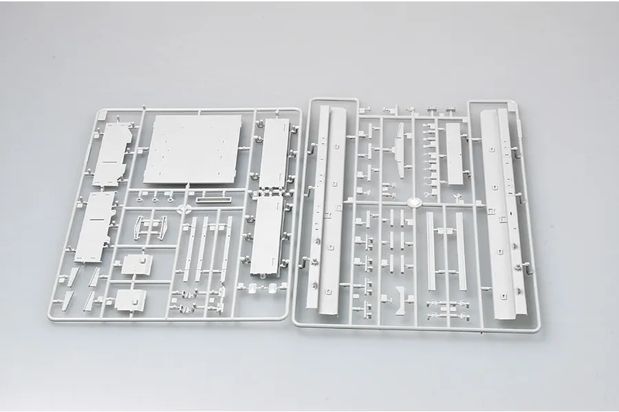 Two grey plastic model kit sprues containing various flat panels and structural components for a 1/35 scale military vehicle model.