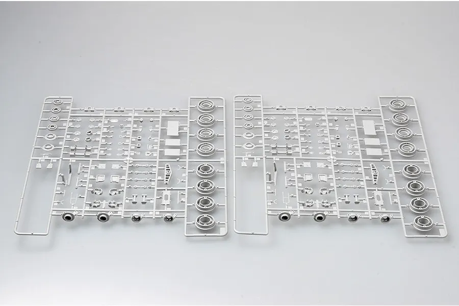 Two identical grey plastic model kit sprues containing various vehicle parts and wheel hubs for a 1/35 scale model.