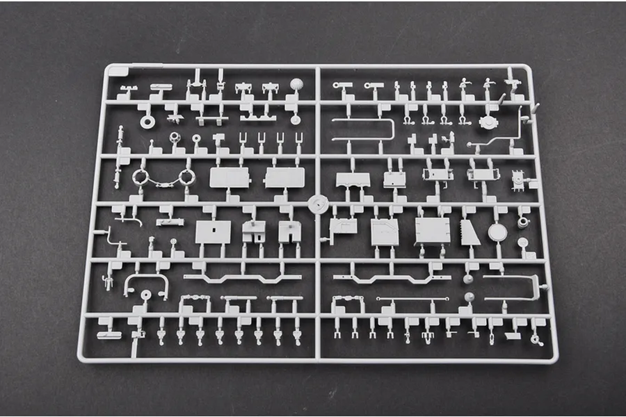 A grey plastic model kit sprue containing various small parts for a 1/35 scale military vehicle model.