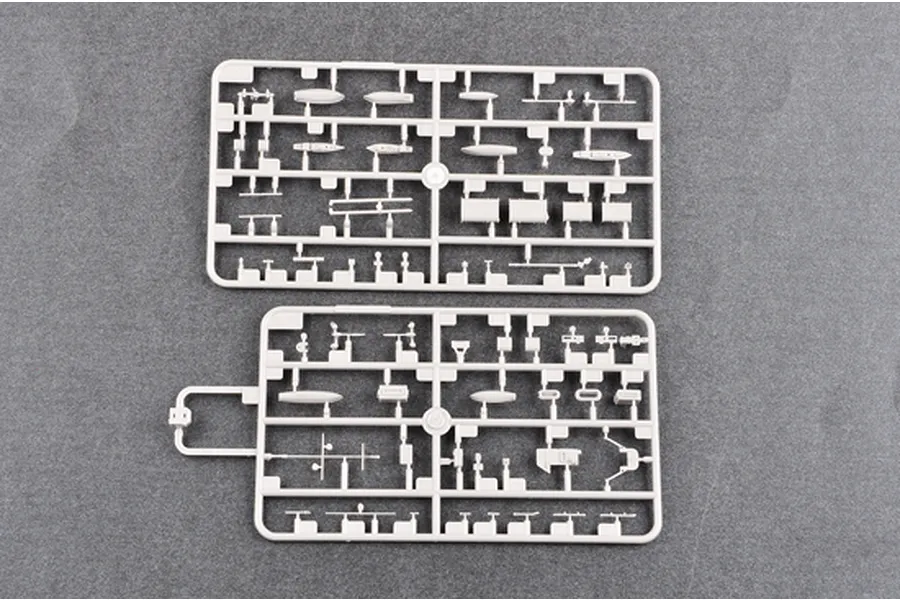 Two grey plastic model kit sprues containing various small ship parts, viewed from above on a dark grey background.