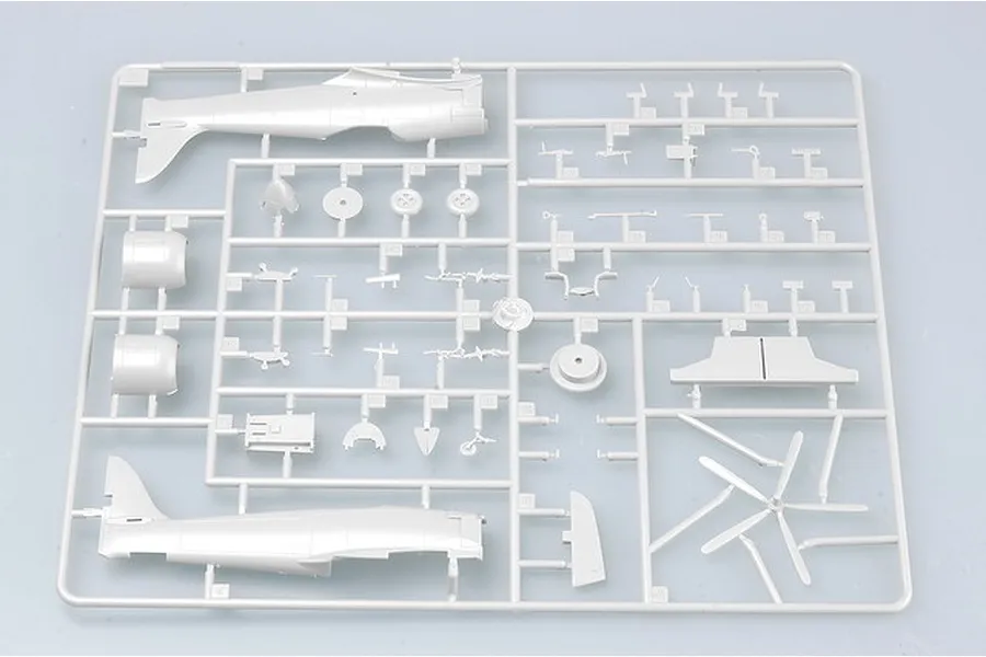 A grey plastic sprue containing various aircraft model parts for a Trumpeter Sea Fury kit, including fuselage halves, propeller blades, and landing gear components.