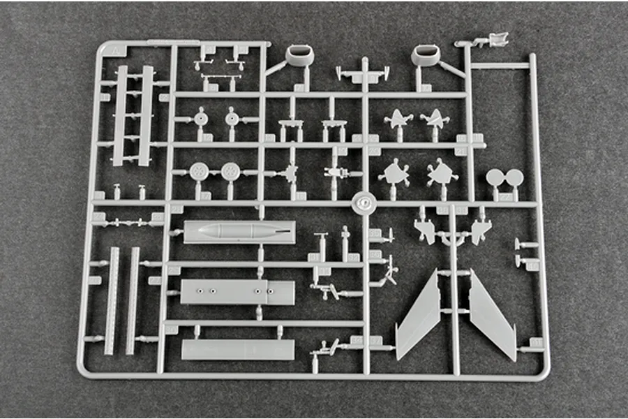 A grey plastic sprue from a Trumpeter 1/72 scale Nanchang Q-5C model kit, featuring various aircraft parts including wings, landing gear, and external stores.