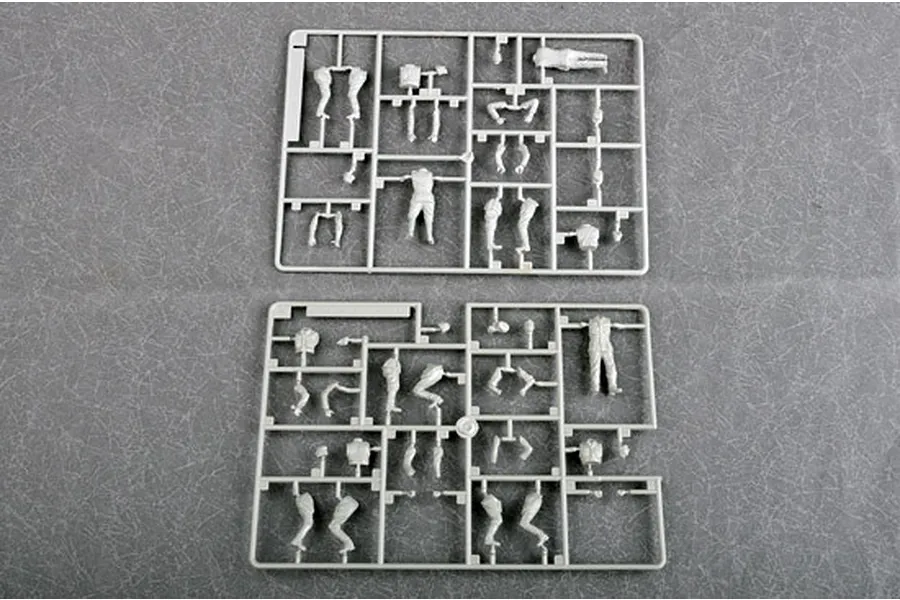 Two grey plastic model kit sprues containing various unassembled soldier figure parts on a grey textured background.