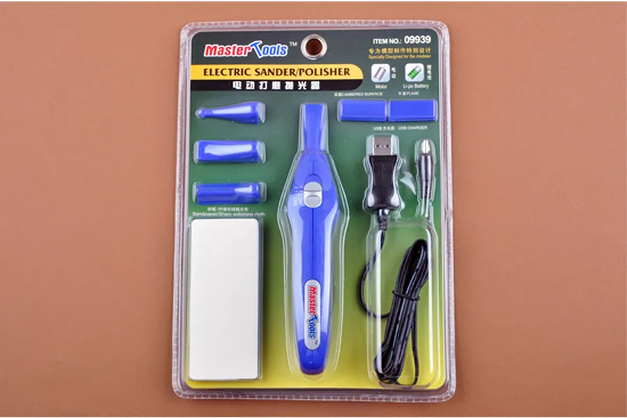 Trumpeter Master Tools electric sander and polisher kit in its original blister packaging, featuring a blue handheld tool, various attachments, and a USB cable.