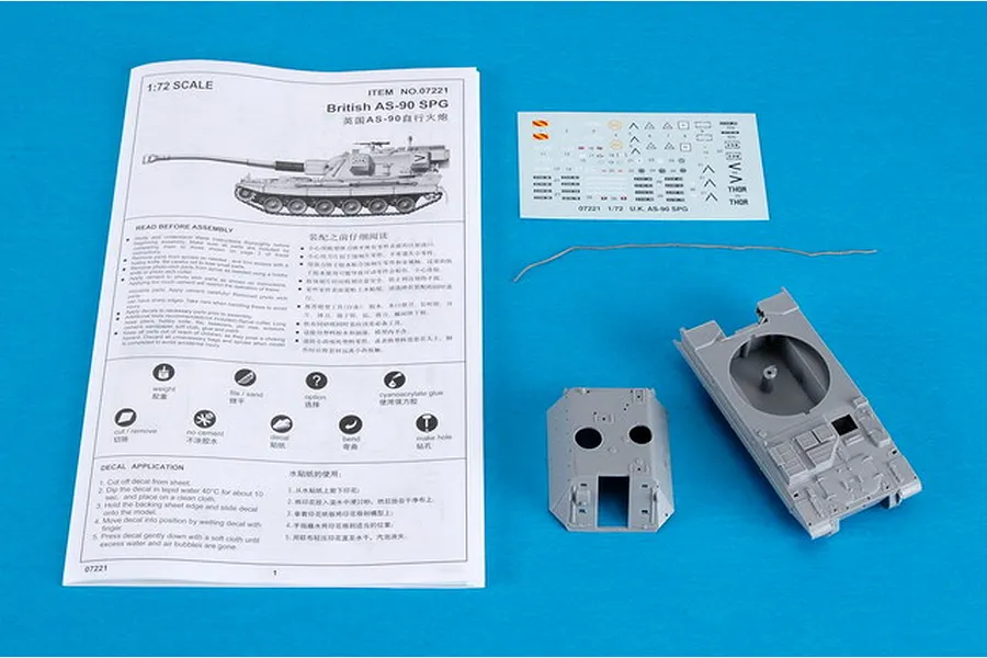 Trumpeter 1/72 scale British AS-90 SPG model kit contents including instruction manual, decal sheet, a piece of string, and two grey plastic tank parts.