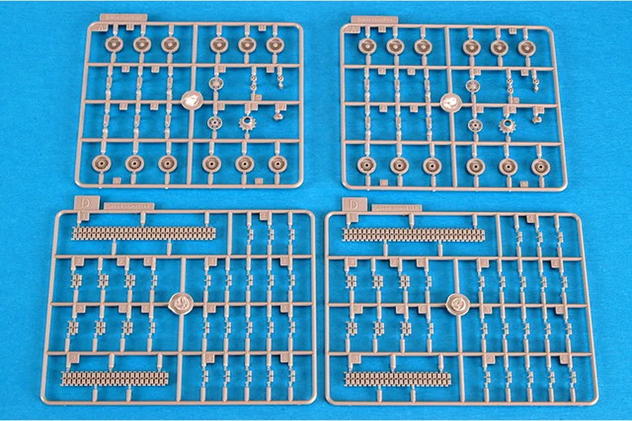 Four plastic model kit sprues for a 1/72 scale AS-90 SPG, showing tank wheels, track links, and suspension parts on a blue background.