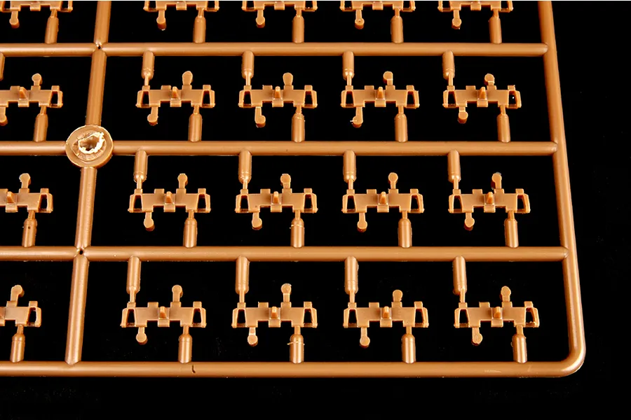 A brown plastic sprue containing multiple individual tank track links for a 1/35 scale model kit.
