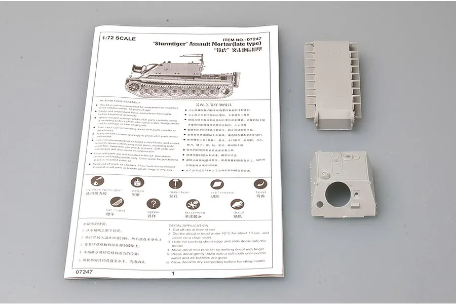 Instruction manual and two grey plastic tank hull parts for a 1/72 scale Trumpeter Sturmtiger model kit.