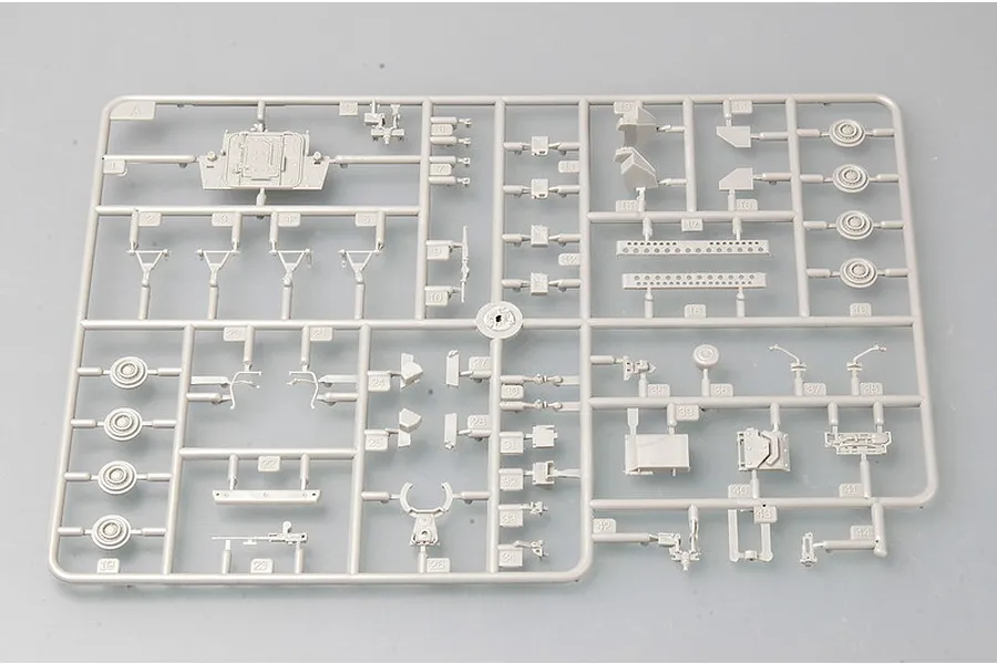 A grey plastic sprue from a Trumpeter 1/72 scale model kit containing various small vehicle parts and wheels.