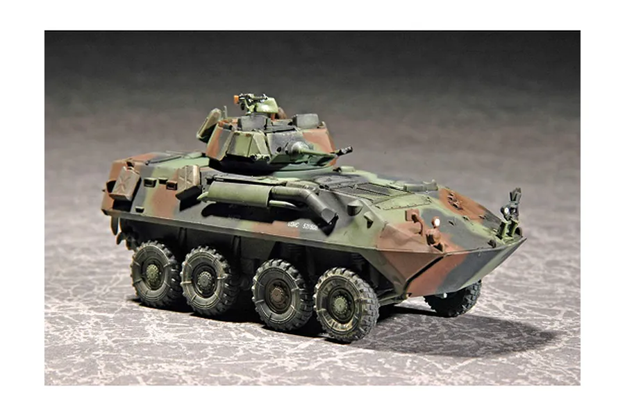 A completed and painted 1/72 scale model of a U.S.M.C. LAV-25 light armoured vehicle with a camouflage paint scheme.