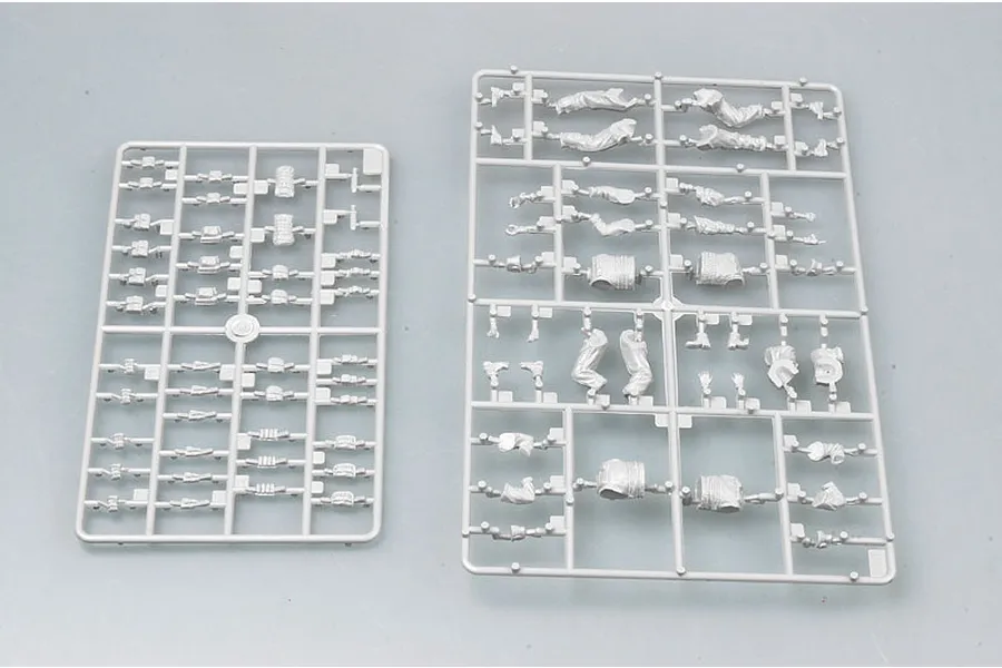 Two grey plastic model kit sprues containing various soldier parts and equipment pieces for a 1/35 scale model.