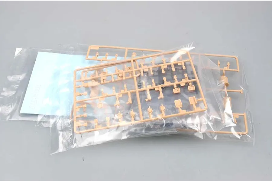 Tan plastic model kit sprues for German KSK Commandos in clear plastic bags on a grey background.