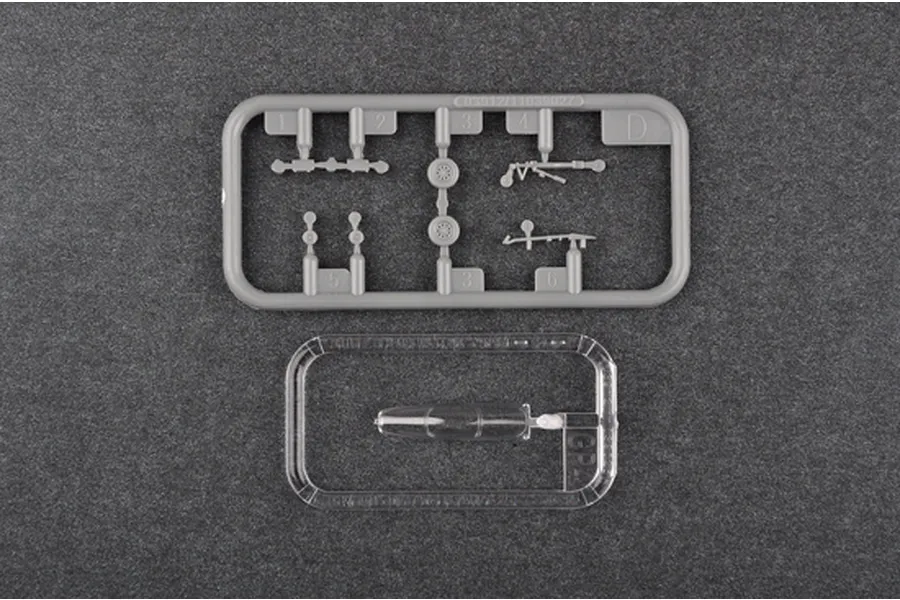 Two plastic model kit sprues for a 1/144 scale Rafale C fighter jet, one grey and one clear, on a dark textured background.