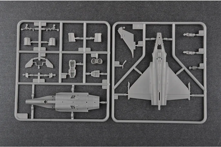 Two grey plastic model kit sprues for a 1/144 scale Rafale C fighter jet, showing fuselage, wing, and landing gear parts on a dark background.