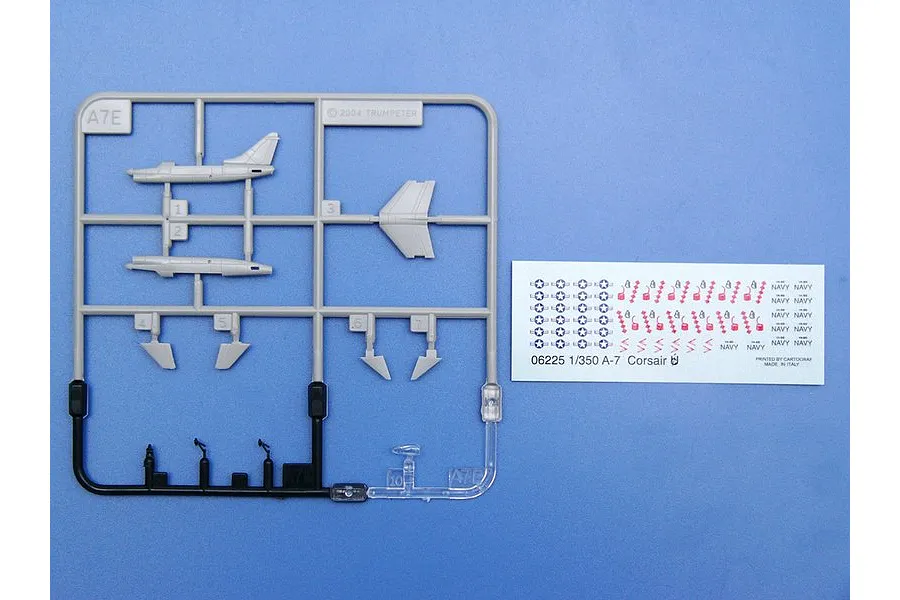 A 1/350 scale Trumpeter A-7E Corsair II plastic model kit sprue and decal sheet on a blue background.