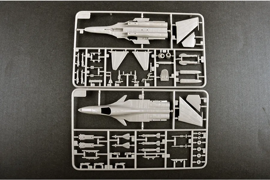 Two grey plastic model kit sprues for a 1/144 scale SU-34 aircraft, featuring fuselage, wings, and missile components on a dark grey background.