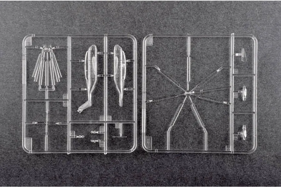 Two clear plastic model kit sprues containing helicopter parts for a 1/350 scale Trumpeter CH-53E Super Stallion model.