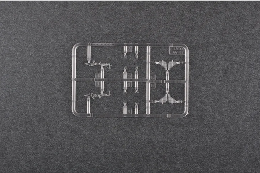 A clear plastic sprue containing 1/700 scale model aircraft parts for an AV-8B Harrier, set against a dark grey textured background.
