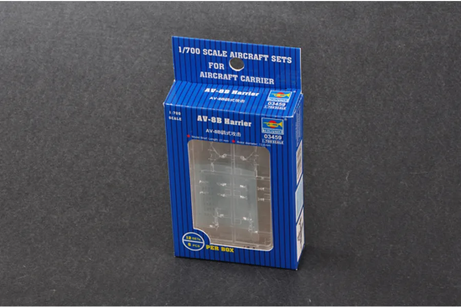 Trumpeter 1/700 scale AV-8B Harrier aircraft model kit box containing 12 pieces, displayed on a dark surface.