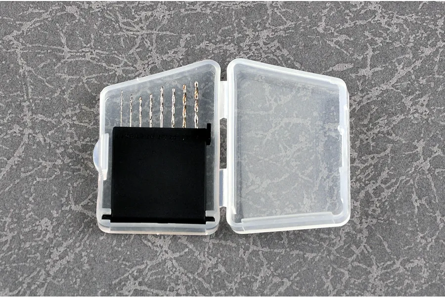 A set of eight small craft drill bits arranged by size in a clear plastic storage case with a black insert.