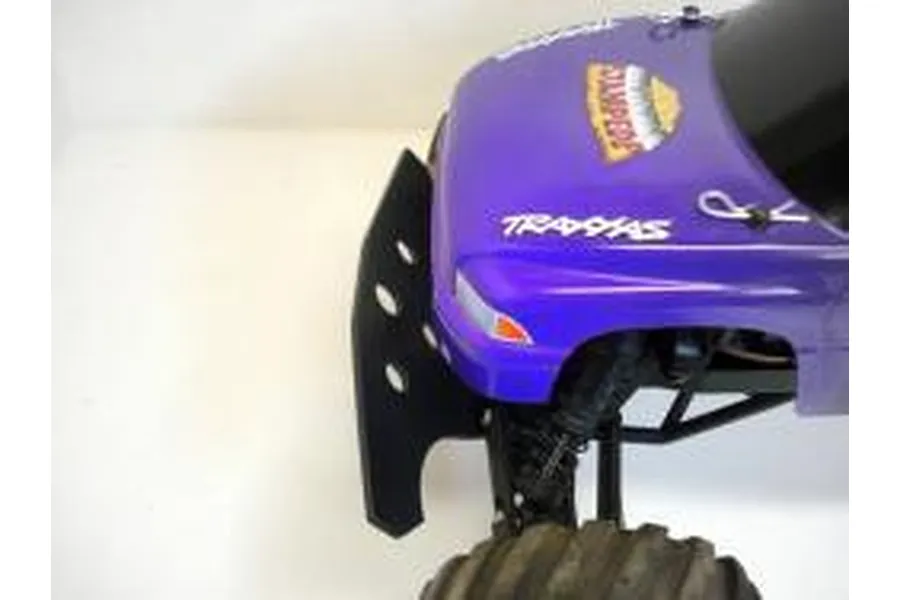 A close-up view of a black T-Bone Racing front bumper installed on a purple Traxxas Stampede 2WD RC truck.