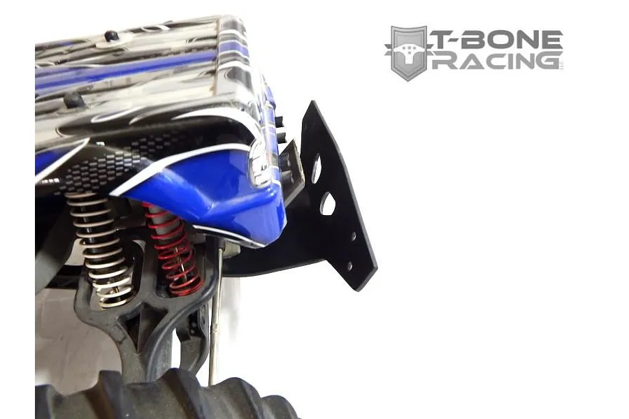 A T-Bone Racing black bumper mounted on the rear of a Traxxas E-Maxx RC monster truck with a blue and black patterned body shell.