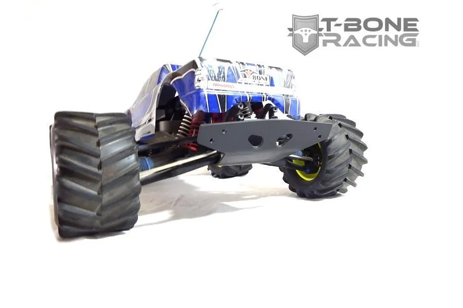 A T-Bone Racing black wide rear bumper installed on a blue and white Traxxas E-Maxx RC monster truck.