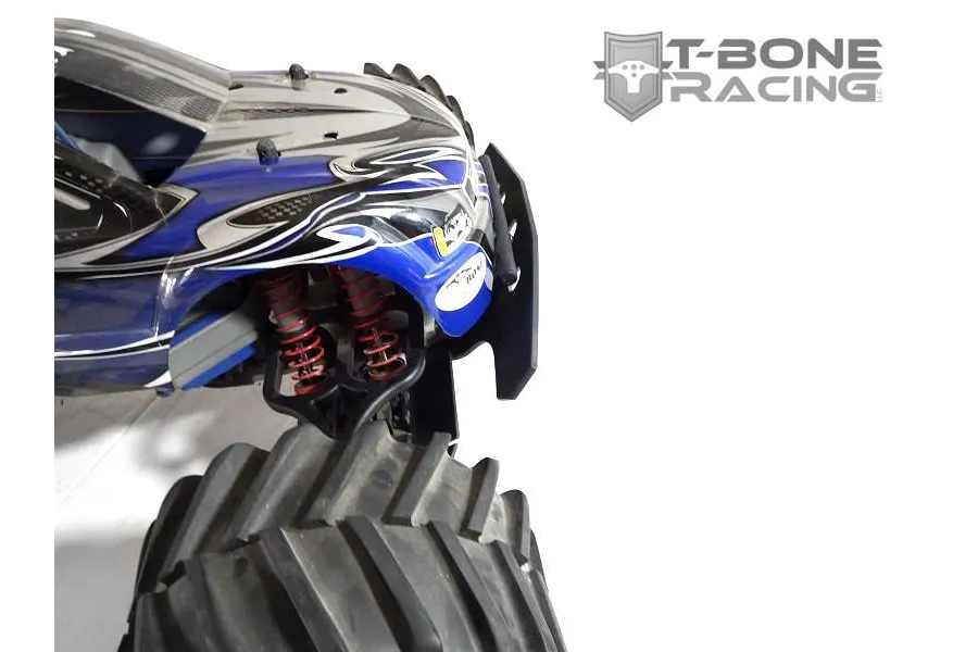 A close-up view of a T-Bone Racing black front basher bumper installed on a blue and silver Traxxas RC monster truck.