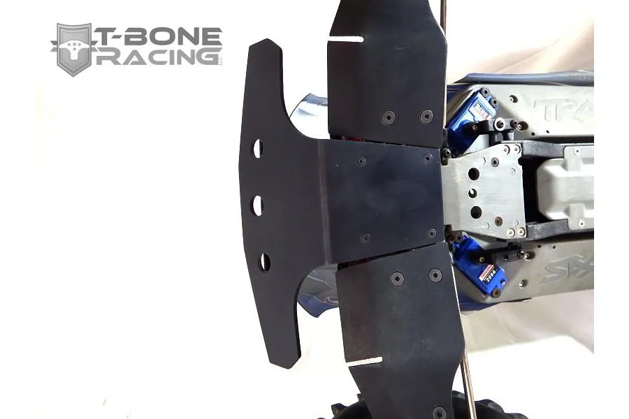 A black T-Bone Racing front basher bumper installed on a Traxxas E-Maxx RC vehicle chassis, viewed from above.