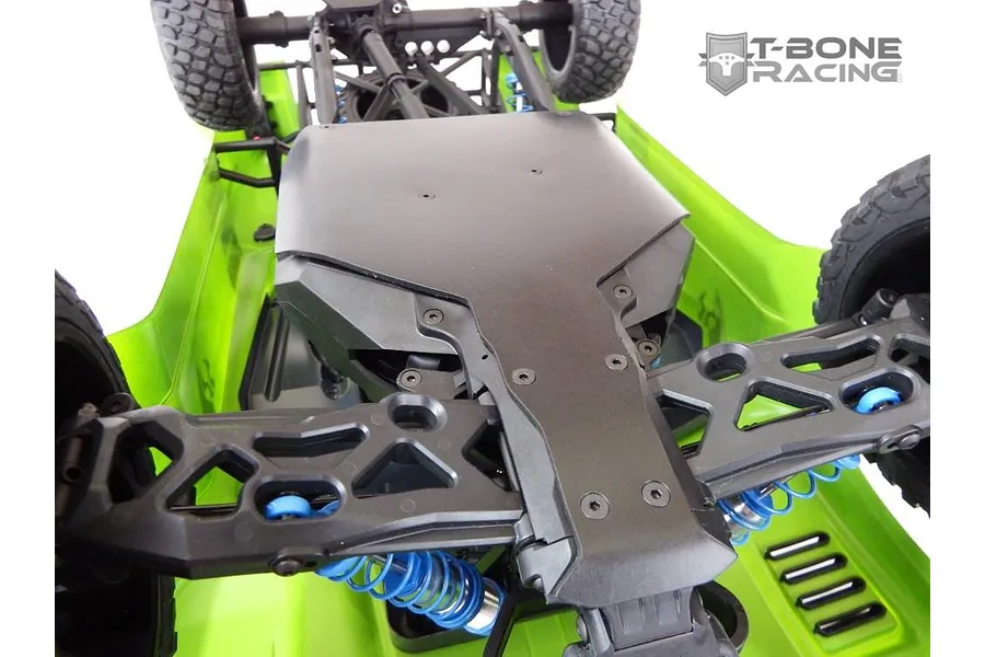 A bottom view of an RC vehicle chassis showing a black T-Bone Racing skid plate installed on a bright green Axial Yeti Score Trophy truck.