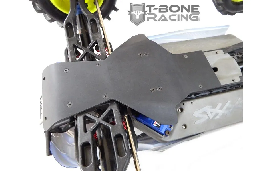 A T-Bone Racing black nylon skid plate installed on the front chassis of a Traxxas E-Maxx RC truck.