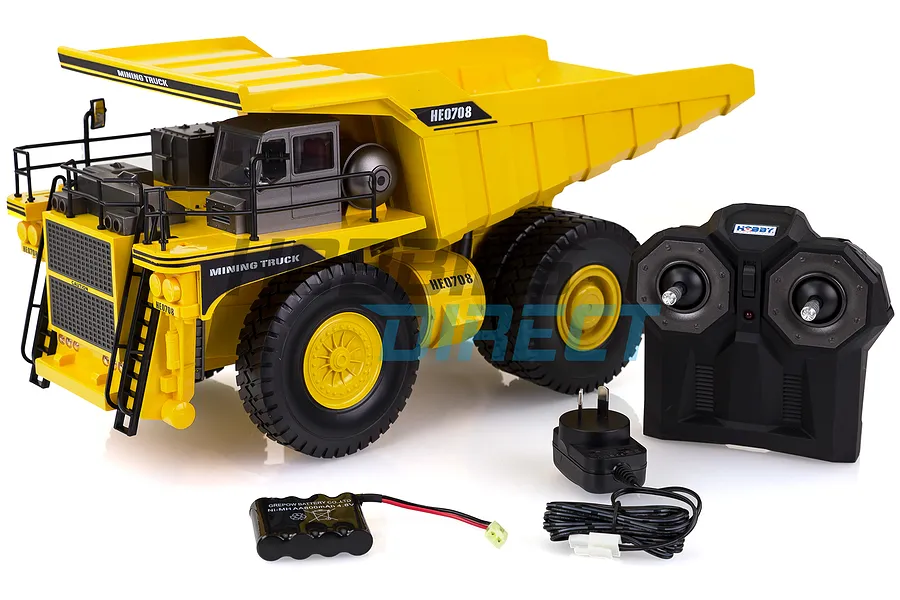 Hobby Engine 1/24 scale RC mining truck in yellow with remote control, battery pack, and wall charger on a white background.