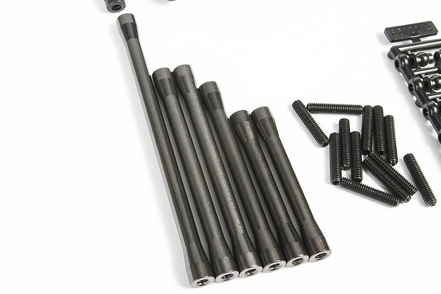 A set of grey aluminium suspension links for an Axial SCX10 II RC car, including threaded metal rods and a plastic parts tree with ball ends.