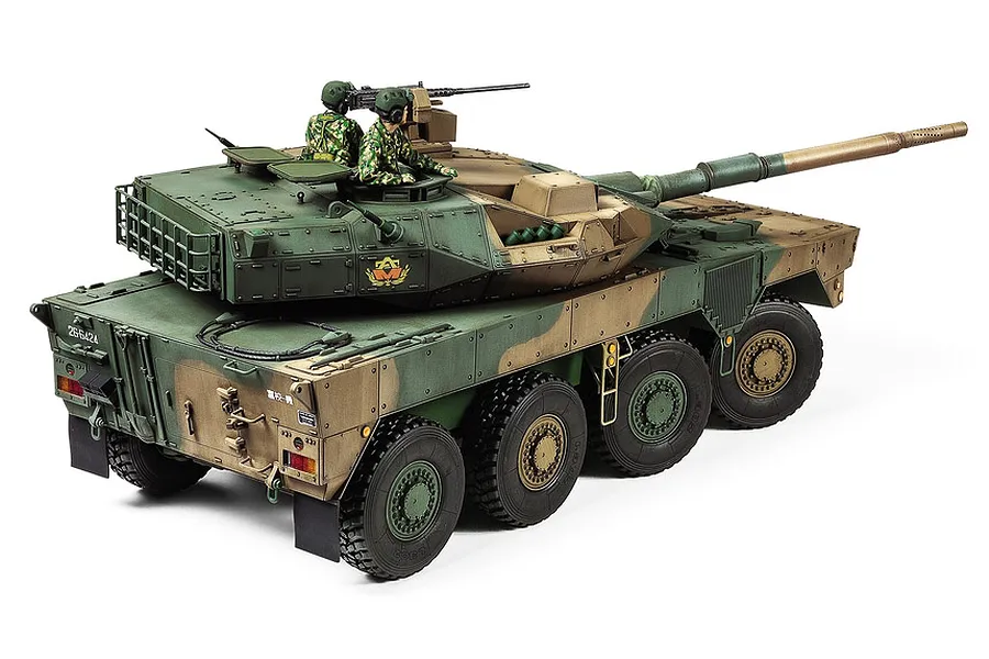 A completed 1/35 scale Tamiya model of a JGSDF Type 16 Combat Vehicle, featuring a camouflage paint scheme and two crew figures.