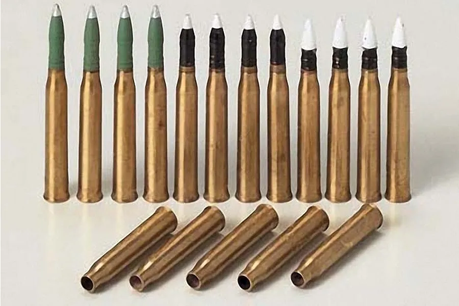A set of 1/35 scale model brass 75mm projectiles for a Tamiya Panther tank, showing upright rounds with green and white tips and empty brass casings.