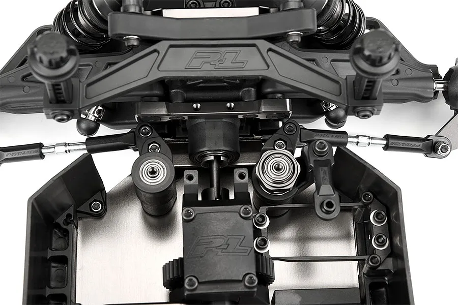 Close-up top-down view of the front chassis section of a Pro-Line PRO-MT RC monster truck roller, showing steering components and suspension mounts.
