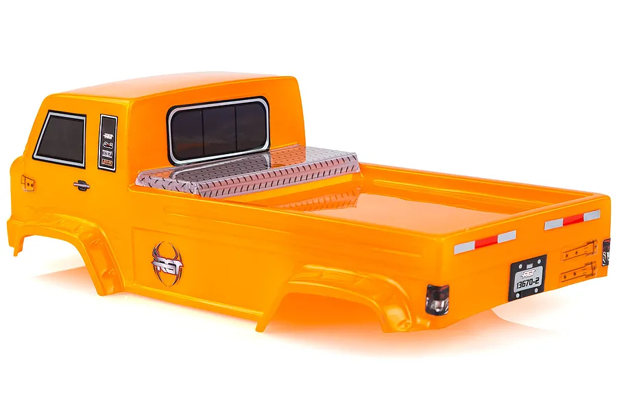 A bright orange pre-painted RC truck body shell for a 1/10 scale off-road recovery vehicle, viewed from the rear three-quarter angle.