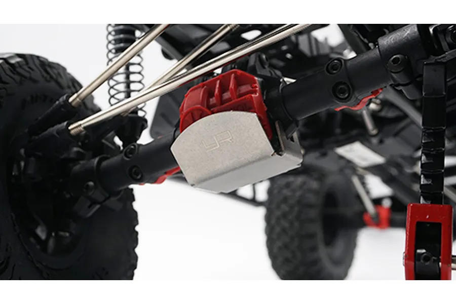 A stainless steel Yeah Racing differential skid plate installed on an RC crawler axle housing.