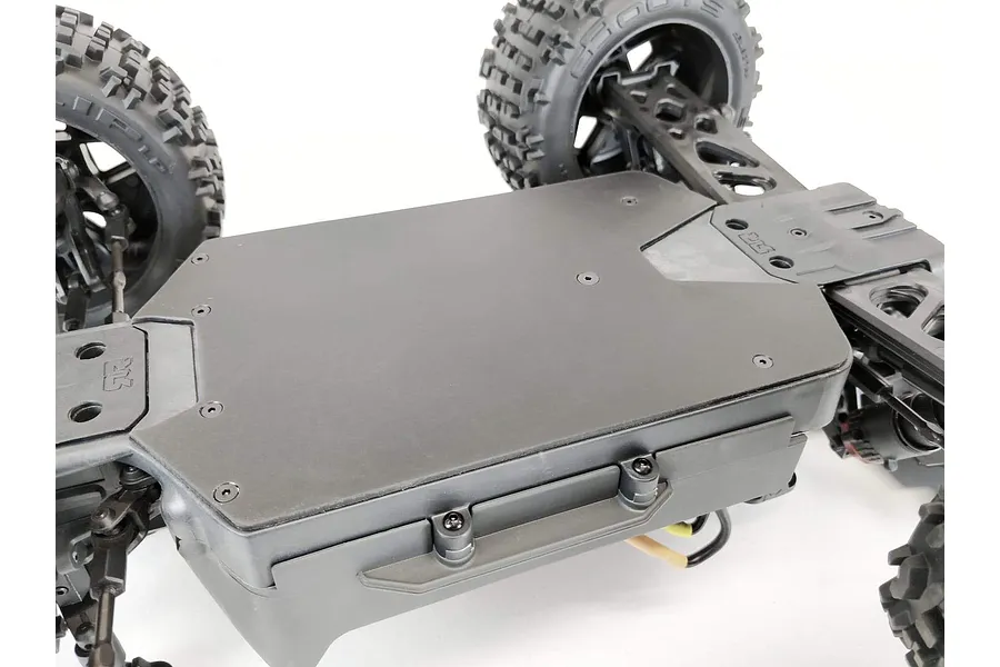 A black T-Bone Racing skid plate installed on the underside of an ARRMA Outcast 4S RC vehicle chassis.