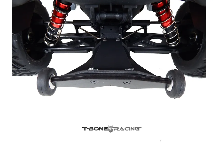 A T-Bone Racing wheelie bar installed on the rear of an ARRMA Kraton RC vehicle, featuring a black nylon skid plate and two small rubber wheels.