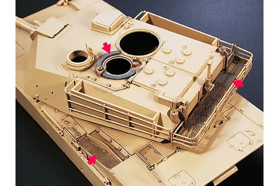 A 1/35 scale model of an M1 Abrams tank turret with photo-etched parts installed, highlighted by red arrows.