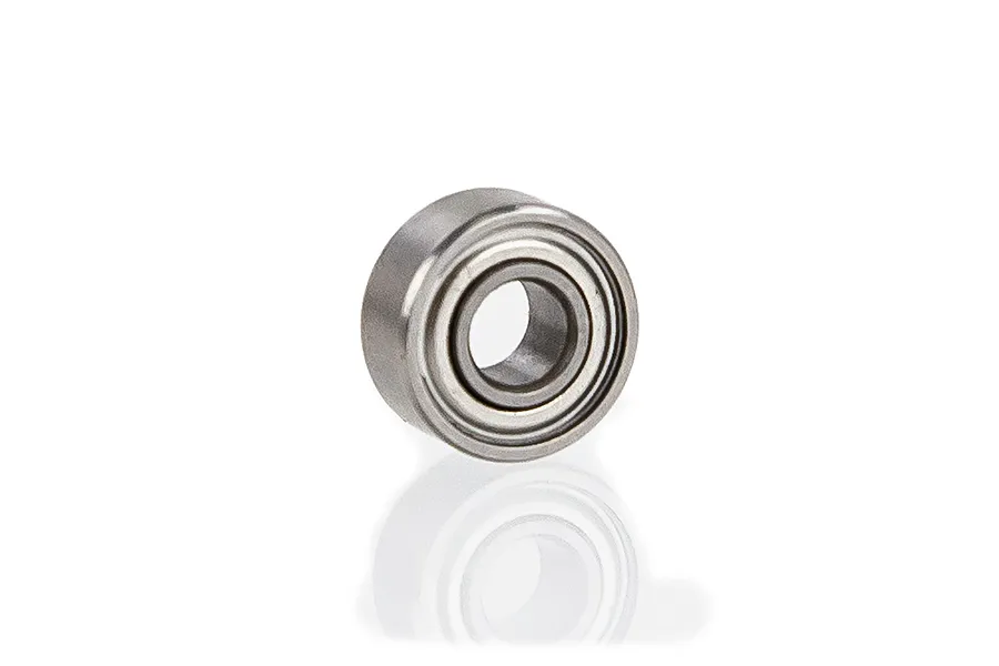 A single metal shielded ball bearing for RC vehicles, shown at an angle against a white background with a soft reflection.