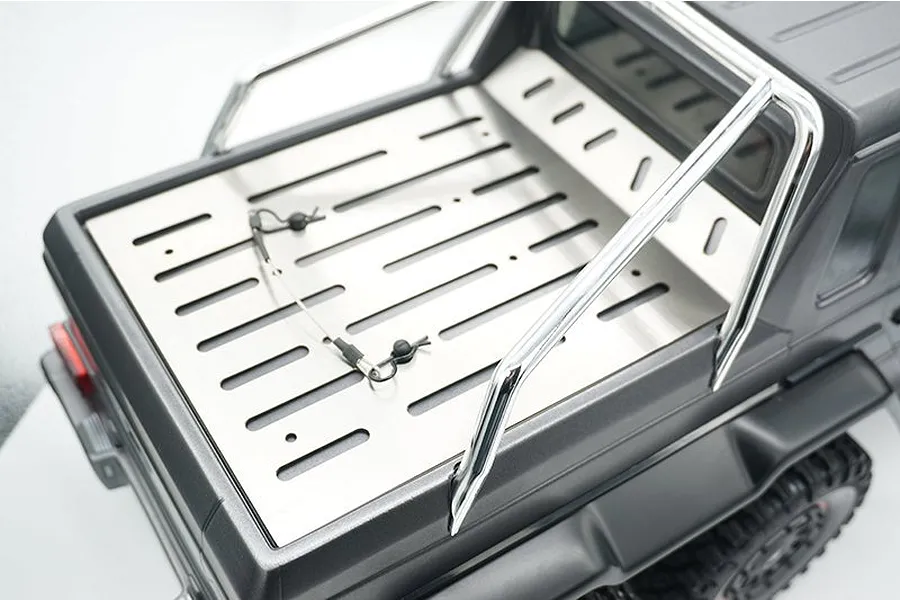A stainless steel tray cover installed on the rear bed of a dark grey RC Mercedes-Benz G-Wagon model.